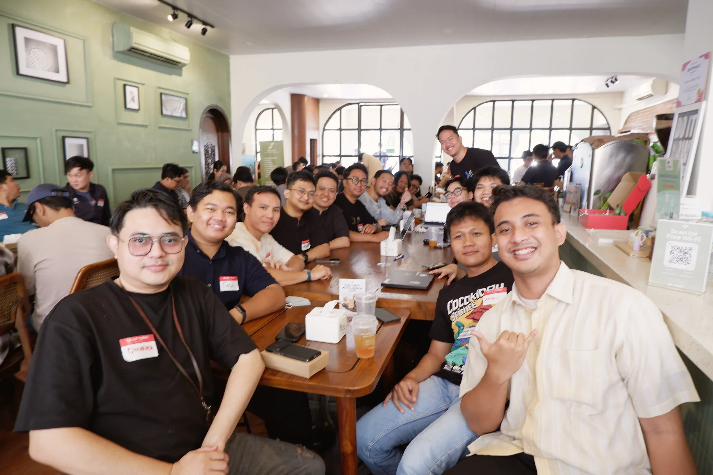 Codex meetup participants smiling toward the camera around a long table